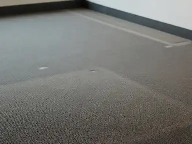 Furniture ghost marks in the carpet of an emptied office suite, part already cleaned