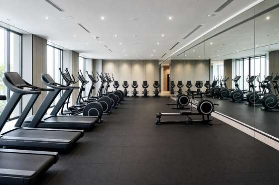 Fitness floor with cardio machines wiped down and rubber matting cleaned between sessions