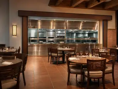 Restaurant dining room seen from the kitchen pass
