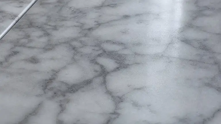 Polished marble floor under a cured sealer, gray veining and an even sheen