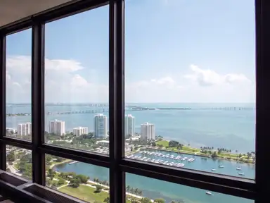 Upper-floor window wall after cleaning, the bay and the causeway sharp through every pane