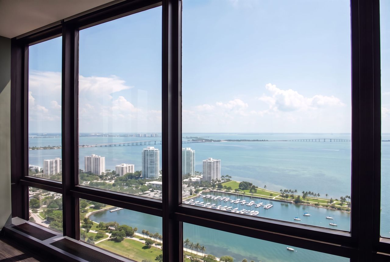 Upper-floor window wall after cleaning, the bay and the causeway sharp through every pane